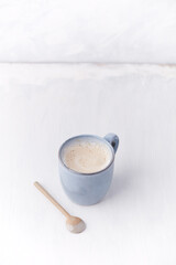 Cappuccino on bright wooden background. Copy space.	