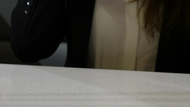 Glass filled with cold drinking water in woman hand, lady rise it up to take gulp. Simple beverage at cheap Chinese restaurant, closeup shot