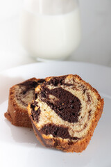 Close up view of Marble cake slice on white plate and wooden table. High quality photo