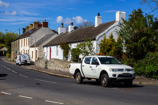 A council owned white bodied Mitshibushi L200 pick up truck driving through Greyabbey village in County Down Northern Ireland
