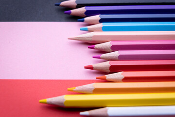 Colorful pencil set on pink, red background