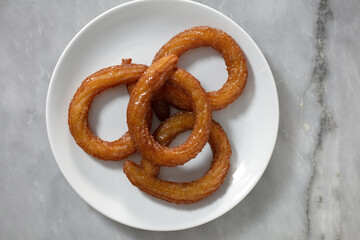 Traditional Turkish ring sweet dessert Halka Tatli. Fried circle desserts. Arabic Ramadan Kareem sweet desserts on table. 