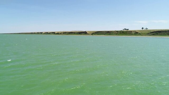 Flight over the smooth surface of the water of an artificial reservoir