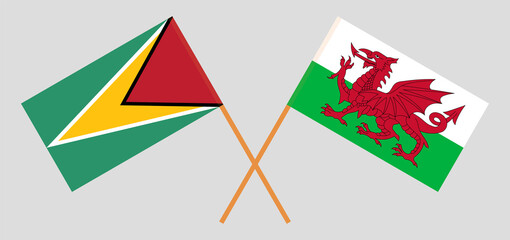 Crossed flags of Guyana and Wales. Official colors. Correct proportion