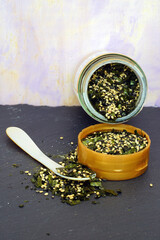 A jar of furikake, a Japanese condiment with dried nori seaweed and sesame seeds