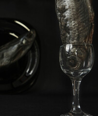 Insane still life with fish inside glass in a dark backdrop