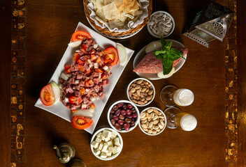Traditional Middle Eastern food. Lebanese food. Arabian raw meat salad, berr glass, kibbeh, tomatoes, top view