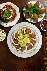 Traditional Middle Eastern food. Lebanese Sfiha meat. Arabian sfeeha plate. Esfiha with lemons. Kibbeh Kibe. Top View
