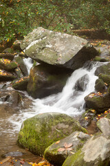Naklejka na ściany i meble Cascading stream with rocks