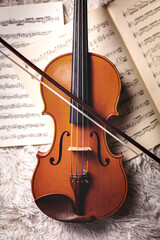 Fototapeta na wymiar Violin on sheet music with bow