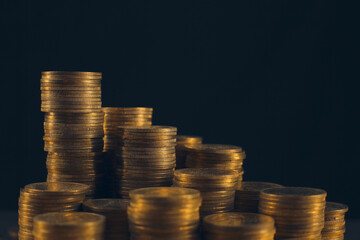 A large variety of coins on a black background. Stack of coins