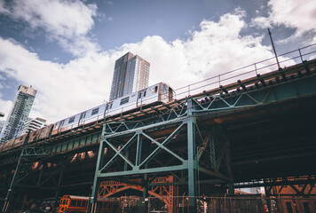 bridge in the city train metro building sky blue clouds New York 