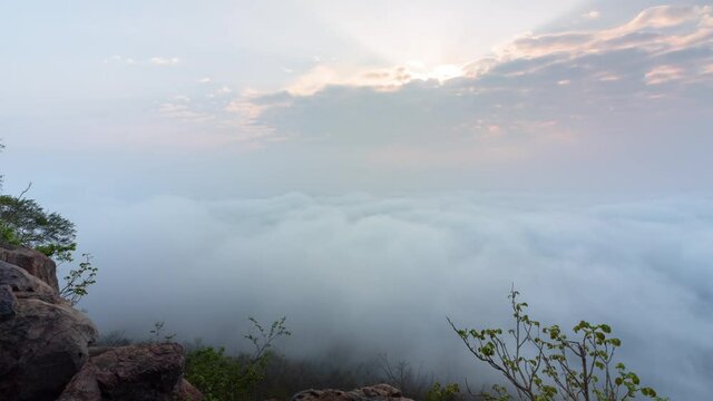 Timelapse clouds moving fast in during sunrise. view of fog flowing from the top of a mountain, Khao Phra Ya Dern Thong View Point Lopburi Thailand