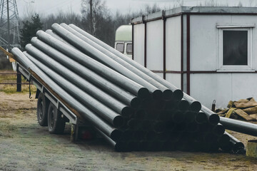 A pile of polyethylene pipes industrial materials loaded and storage outdoor at a construction site