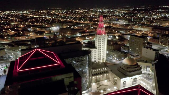 Downtown Buffalo, New York at night Aerial. Shiny glass buildings against a snowy ground. Part of a series of clips, each showing a different angle of the city and different contents in the frame.