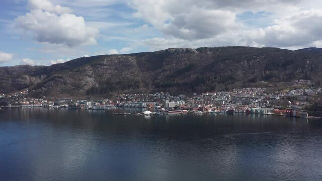 Slow aerial orbit Sandviken with Skuteviksboder and Stoltzekleiven mountain behind - Norway