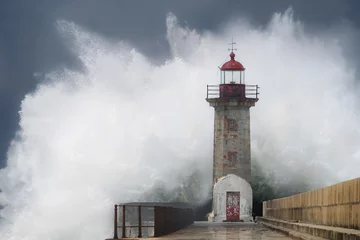 Fotobehang Wave crashing on lighthouse © Eduardo