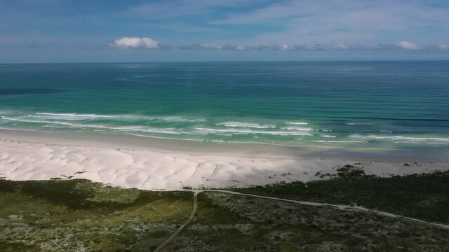 Aerial View Of Beach Coastline With South Atlantic Ocean Waves Breaking. Follow Shot