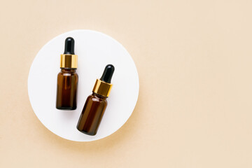 Obraz premium Dark brown glass dropper bottles for medical and cosmetic use. SPA concept. Top view, copy space