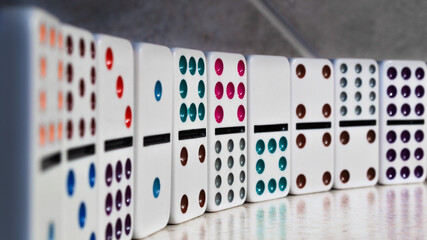 Domino toy tiles stacked on a table and copy space background. Old childhood toys and fun games. Reaction and risk management concept