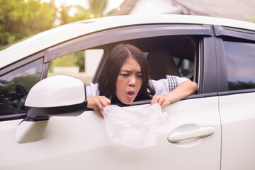 Asian woman puke or vomiting into plastic bag in car,Car Sick and motion sickness