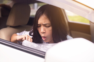 Woman puke or vomiting into plastic bag in car,Car Sick and motion sickness