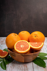 Fresh Cara Cara Orange slices and leaves in Wooden background, Fresh Cara Cara Orange in basket on wooden Background.