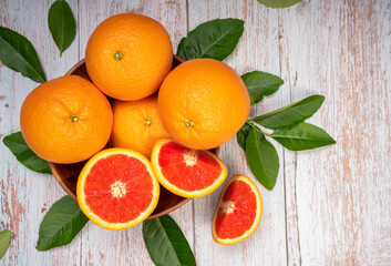 Fresh Grapefruit with Grapefruit slices and leaves in Wooden background, Fresh Grapefruit in basket on wooden Background.