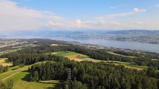 Aerial drone shot above Pfannenstiel flying towards lake Z&uuml;rich in Switzerland