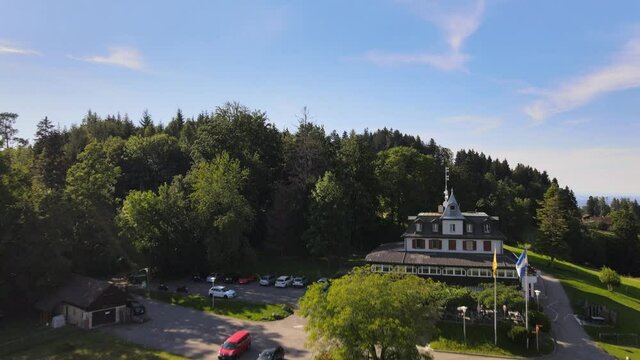 Aerial drone shot of Hochwacht-Pfannenstiel flying forwards and up showing the hill