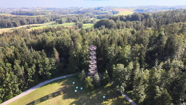 Aerial drone shot flying down and tilting up showing the Pfannenstiel observation tower