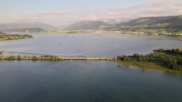 Aerial drone shot flying sideways overlooking the bridge between Rapperswil and Hurden on a summer evening
