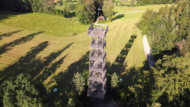 Aerial close drone shot flying around the Pfannenstiel observation tower in the canton of Z&uuml;rich, Switzerland
