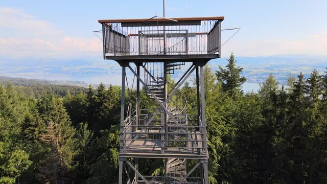 Aerial drone shot close to Pfannenstiel observation tower flying up and revealing lake Z&uuml;rich in the background