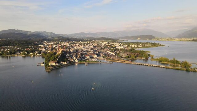 Aerial drone shot flying backwards showing Rapperswil on a summer evening