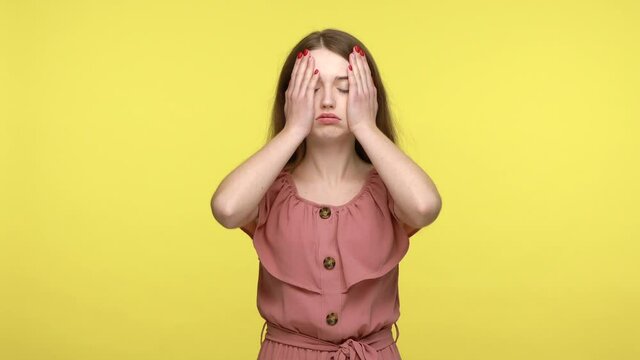 Mind blowing information. Overwhelmed woman making explosion gesture as her head gonna explode, being angry and nervous, having problems. Indoor studio shot isolated on yellow background.