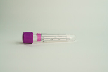 Obraz premium vacuum tube for collection and blood samples on white background..Transparent with purple lid. Label to identify the data. Selective focus. lid. Label to identify the data. Selective focus.