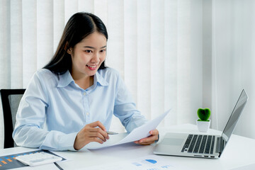 Businesswoman analysis the chart and meeting Video Conferencing with laptop at the home office for setting challenging business goals And planning to achieve the new target