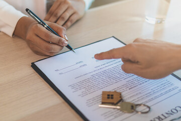 Deal done apartment landlord, banker or realtor man pointing on rent contract renter, tenant or client sign signature on document, paper. Finance,financial of property, estate mortgage or home loan