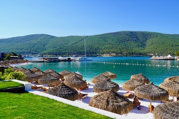 Bodrum, Turkey - August, 2020 Snow-white beach of Lux Hotel with emerald water of Aegean Sea. Yachts. People sunbathing on the beach. Sunbeds on the beach. Relaxing Deluxe Leisure Conception. Paradise