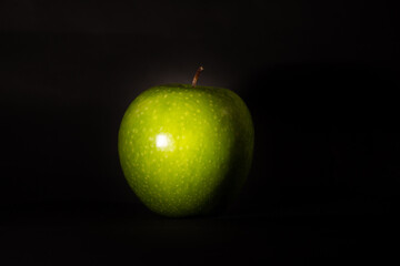 Perfect green apple on dark background