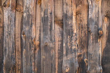 Old wooden wall knocked down from rough planks