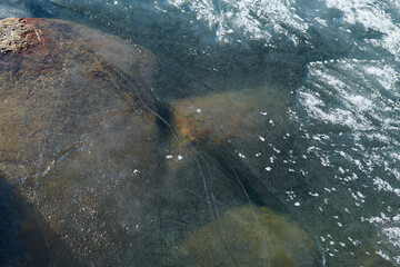 very large stones in the water of the lake