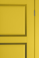 Fragment of new stylish painted yellow wooden door