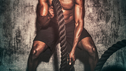 Strong man creating waves with battling ropes wallpaper