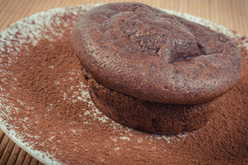 Fresh chocolate muffins on glass plate. Delicious dessert