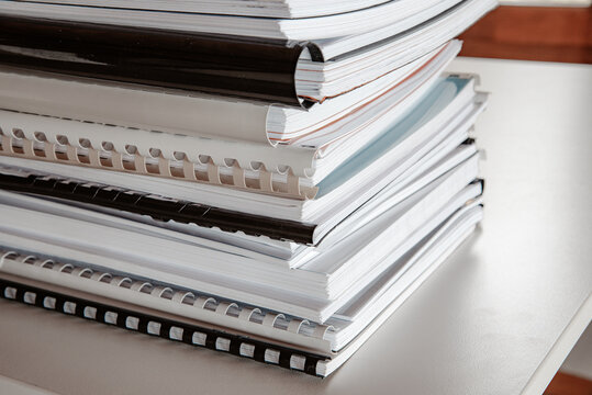 Stack of binded workbooks on a table