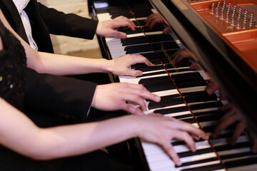 Fototapeta premium playing the piano, couple piano duet