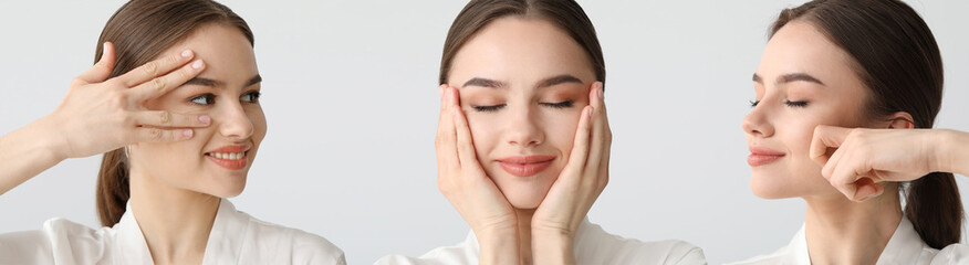 Young woman giving herself face massage on light background