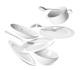 Flying clean tableware on white background
